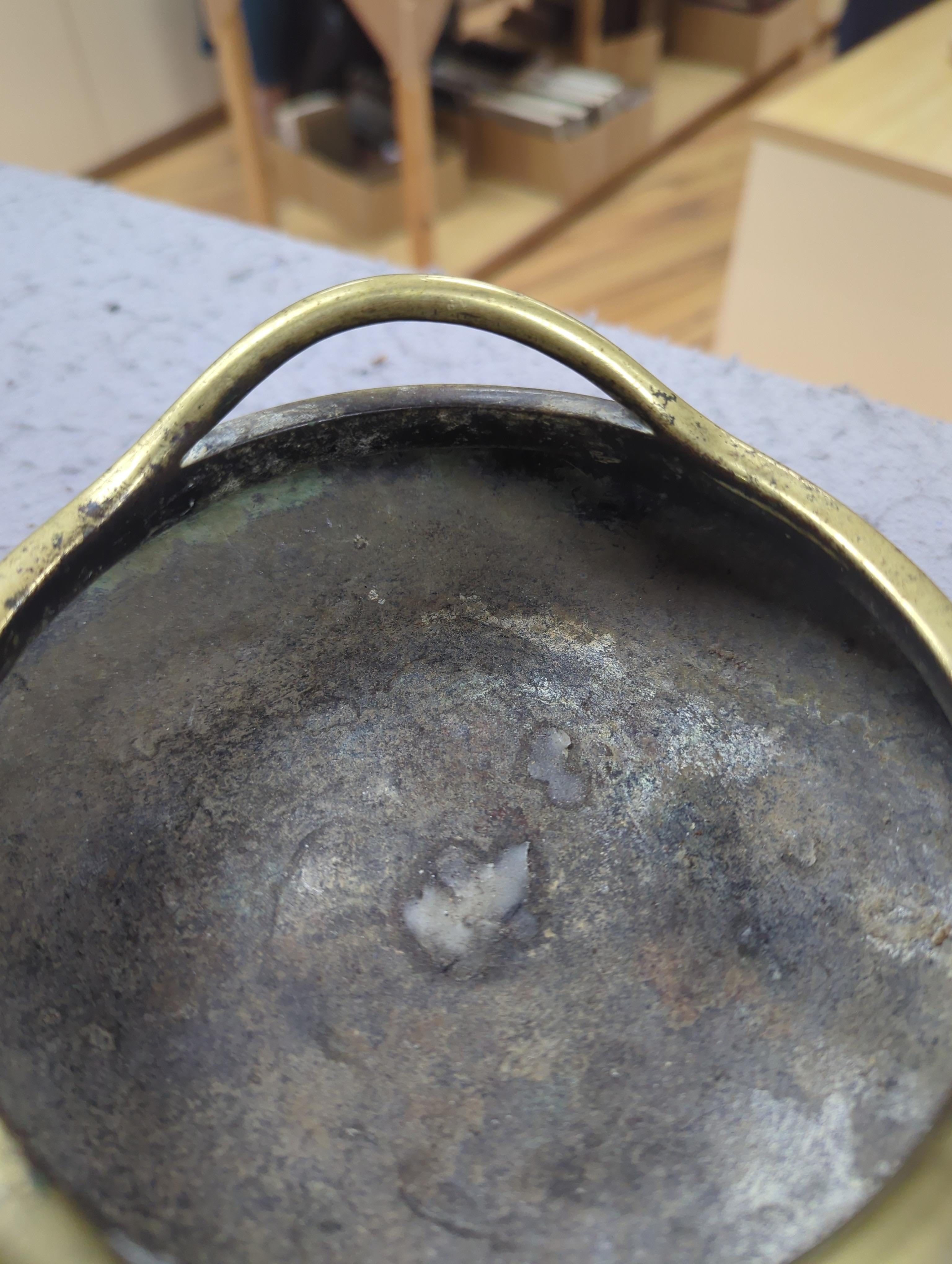 A late 19th century Chinese bronze censer with twin handles, apocryphal Xuande mark, 17.5cm in diameter
